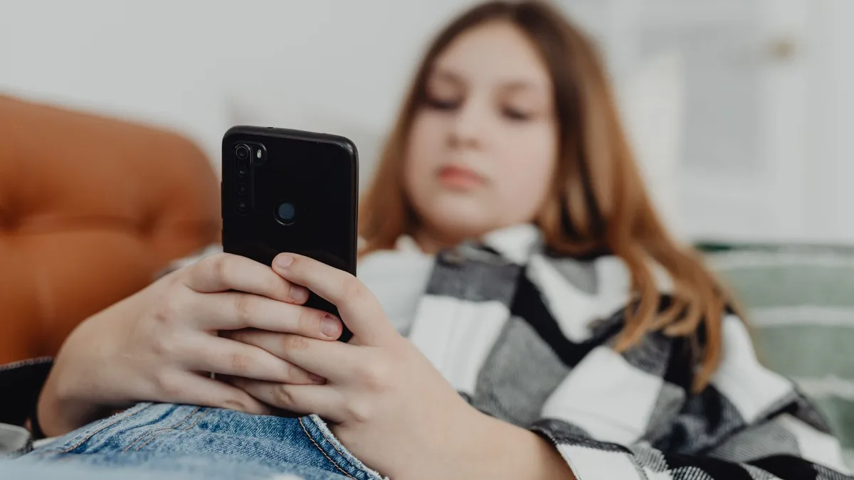 Akıllı telefon ekranına dalmış genç bir kullanıcının yakın plan görüntüsü